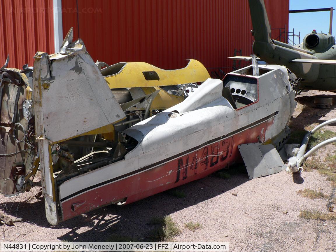 N44831, 1940 Naval Aircraft Factory N3N-3 C/N 2576, Sitting on its belly next to a hangar.