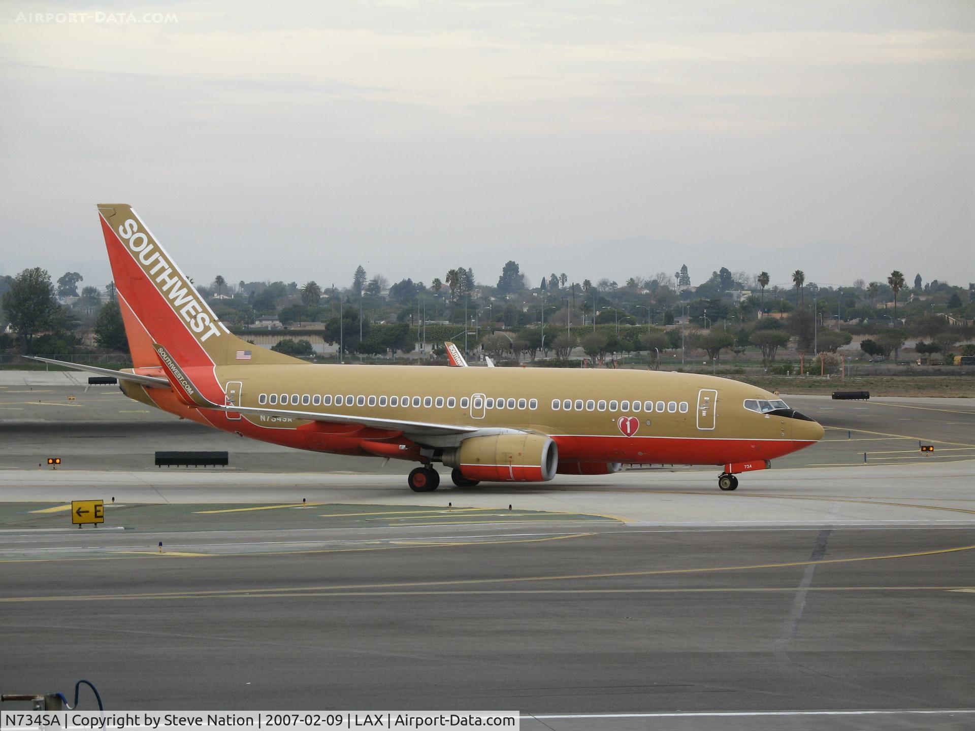 N734SA, 1999 Boeing 737-7H4 C/N 27866, Southwest 737-7H4 in old colors and winglets taxying in to gate @ LAX