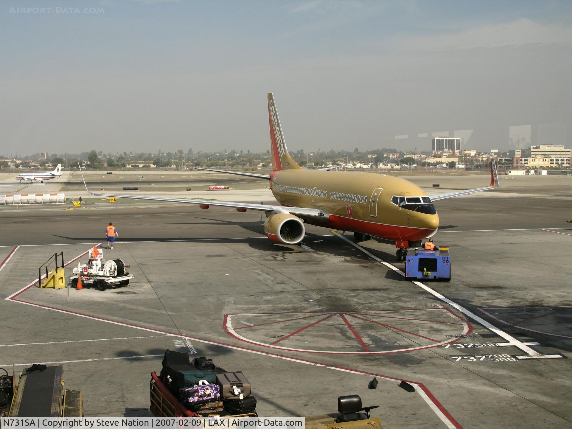 N731SA, 1999 Boeing 737-7H4 C/N 27863, Southwest 737-7H4 in old colors and winglets being pushed back  @ LAX