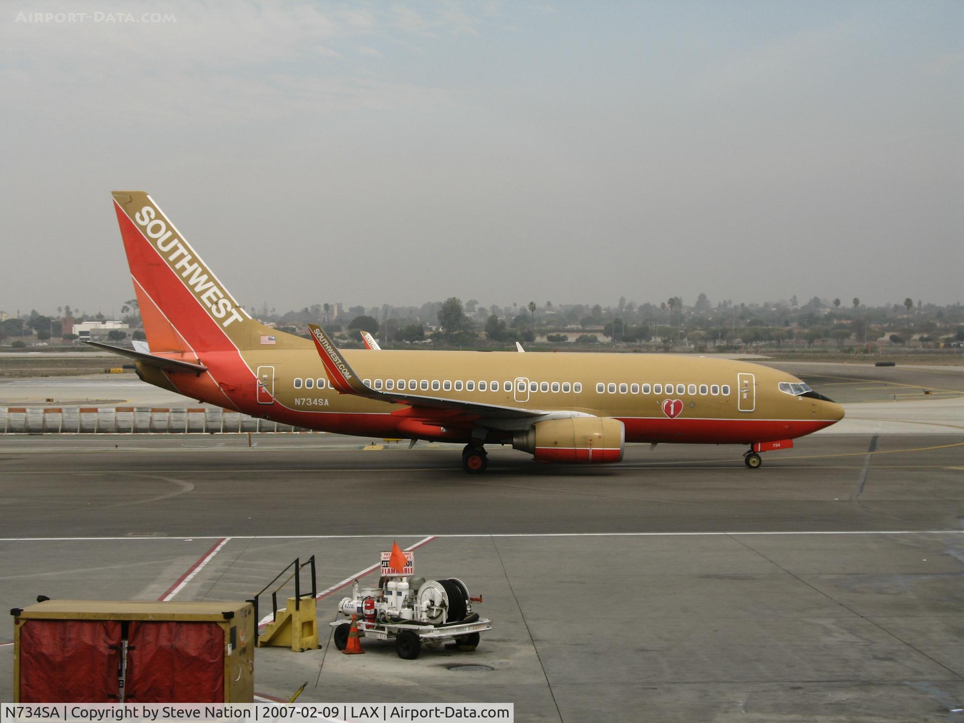 N734SA, 1999 Boeing 737-7H4 C/N 27866, Southwest 737-7H4 in old colors and winglets pushed back and ready to taxying @ LAX