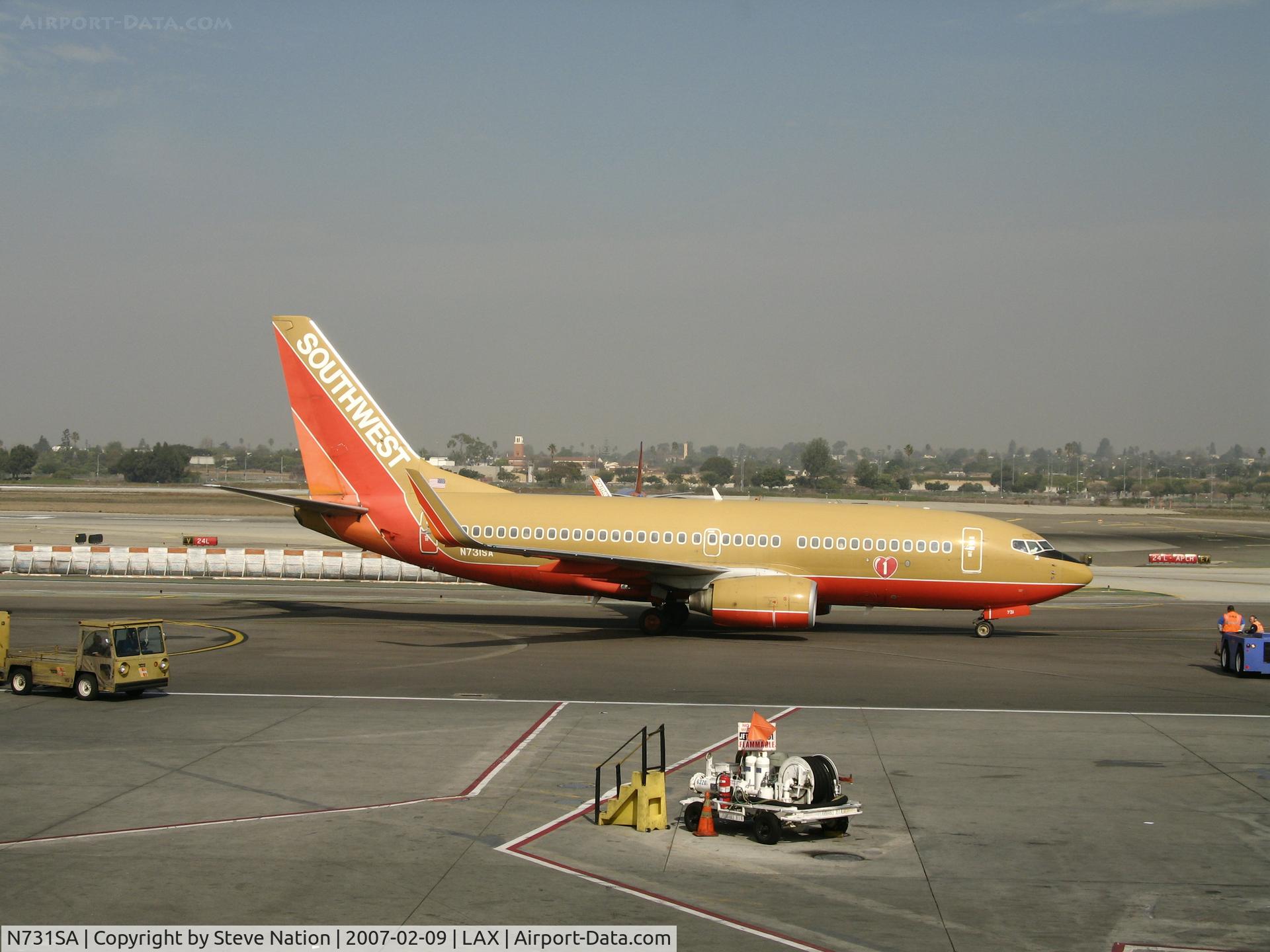 N731SA, 1999 Boeing 737-7H4 C/N 27863, Southwest 737-7H4 in old colors and winglets pushed back  and ready to taxy @ LAX