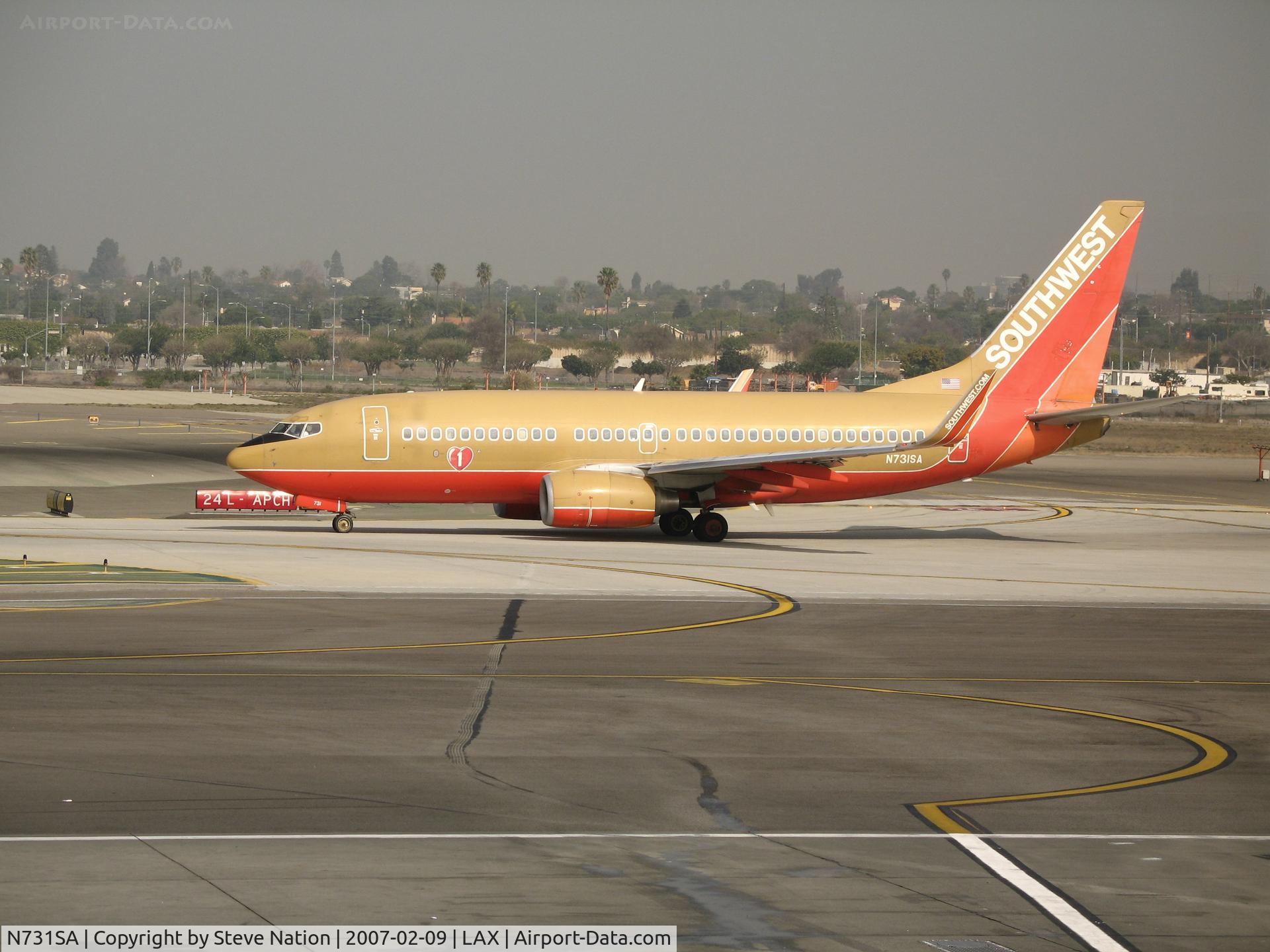 N731SA, 1999 Boeing 737-7H4 C/N 27863, Southwest 737-7H4 in old colors and winglets taxying to active runway @ LAX