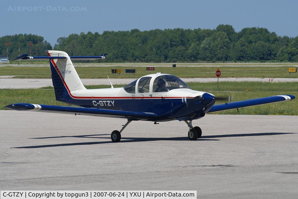 C-GTZY, 1979 Piper PA-38-112 Tomahawk Tomahawk C/N 38-79A1000, Taxiing across Ramp III for departure.