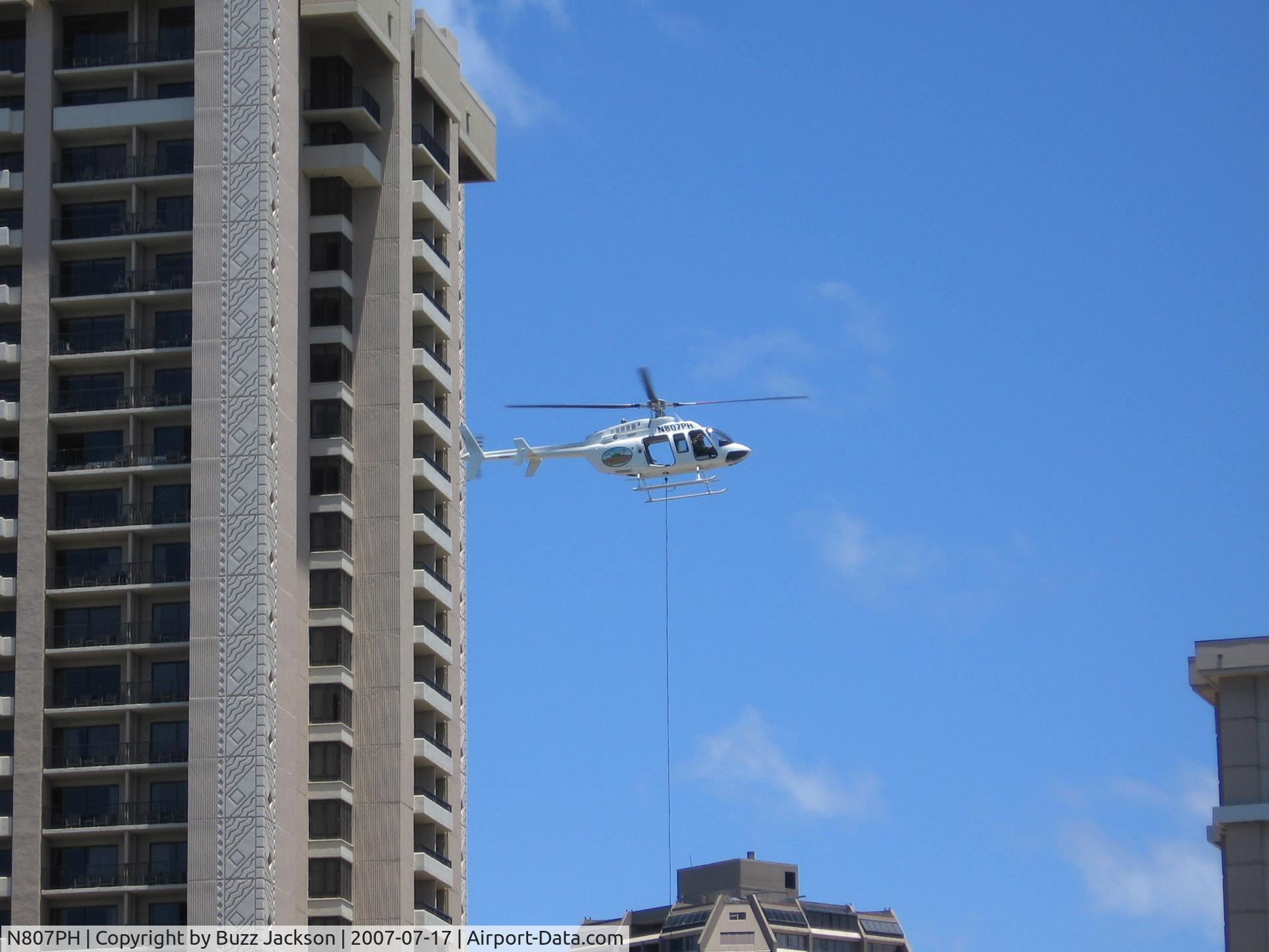 N807PH, 2005 Bell 407 C/N 53656, N807PH lifts air conditioning units up the side of the Hilton at Waikiki, Honolulu