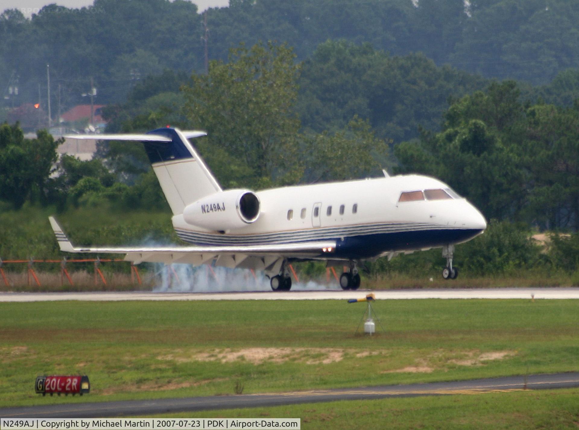 N249AJ, Canadair Challenger 600 (CL-600-1A11) C/N 1047, Smoking tires on landing.