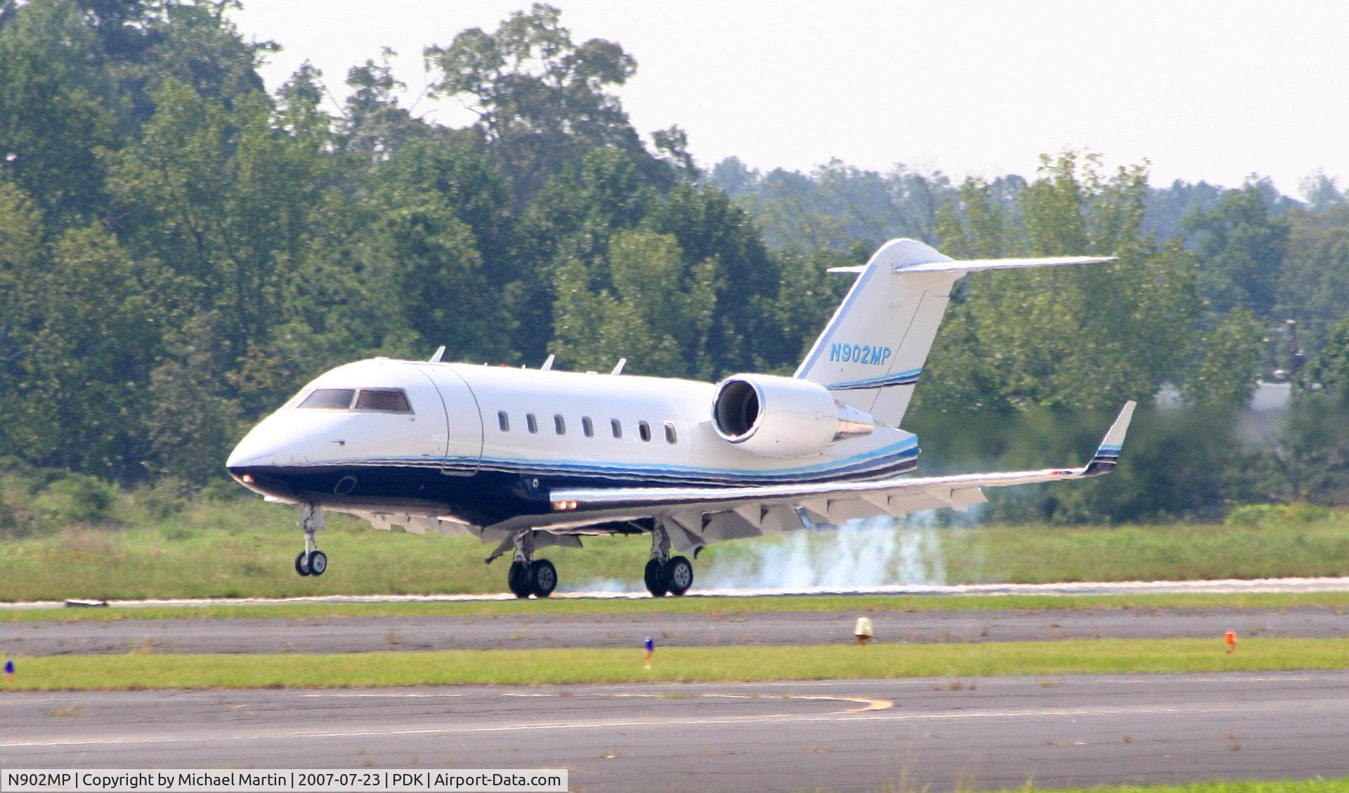 N902MP, 2003 Bombardier Challenger 604 (CL-600-2B16) C/N 5559, Smoking tires on landing.