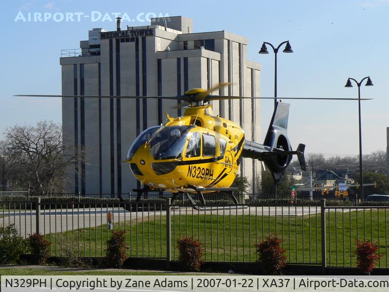 N329PH, 2006 Eurocopter EC-135P-2 C/N 0489, Leaving hospital pad in the medical district @ Ft. Worth, TX