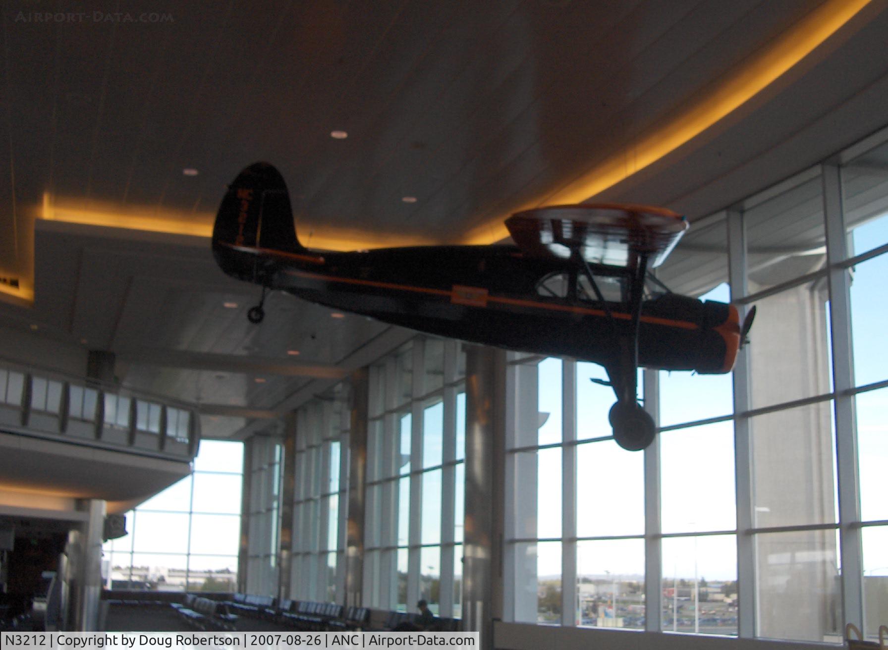 N3212, 1938 Fairchild 24 G C/N 2933, 1938 Fairchild 24G as NC3212, Warner SS40&SS50 Super Scarab 165 Hp radial, an Alaska Aviation Heritage Museum restored asset hanging in ANC South Terminal near C7-C9