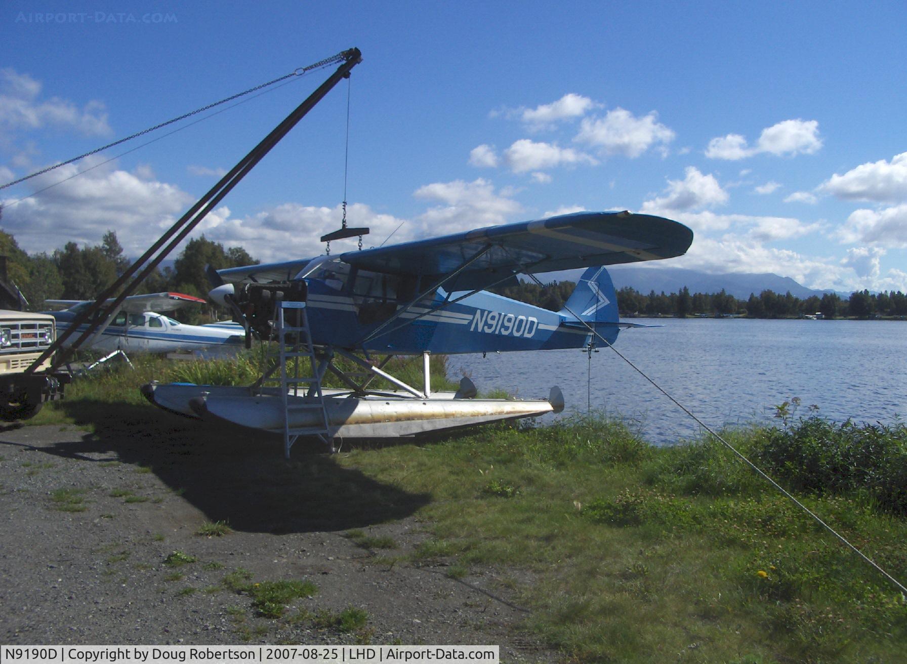 N9190D, 1958 Piper PA-22-160 Tri Pacer C/N 22-6248, 1958 Piper PA-22-160 TRIPACER, Lycoming O-320-B 160 hp, engine maintenance, counterweighted boom truck with sling shows alternate method of lifting a straight-float plane out of water