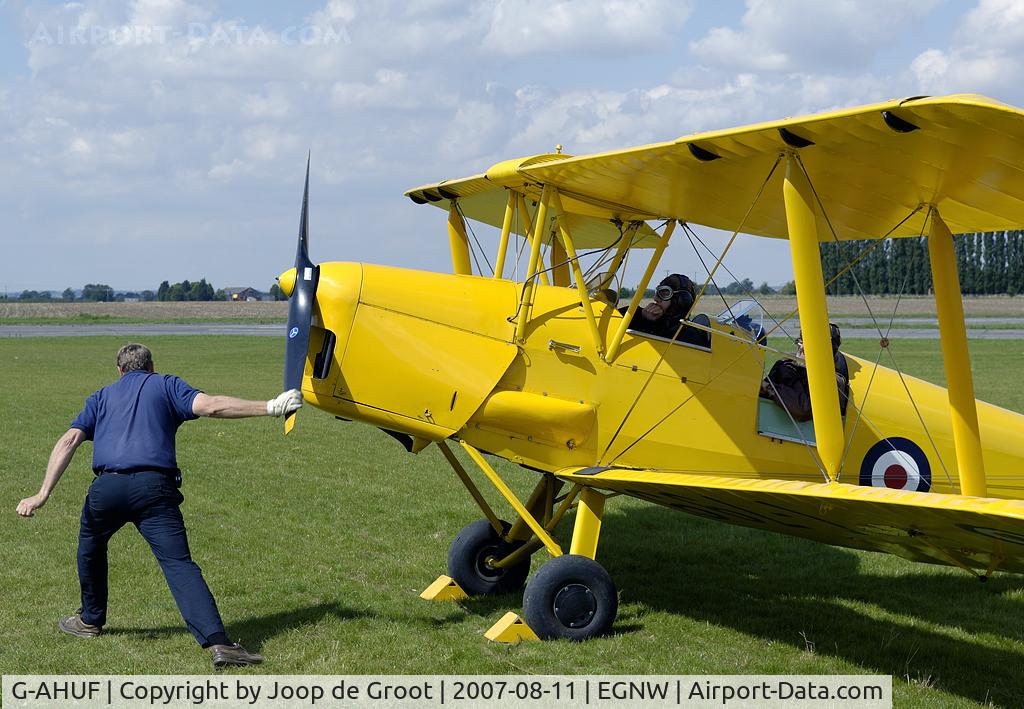 G-AHUF, 1943 De Havilland DH-82A Tiger Moth II C/N 86221, The traditional way of starting an aircraft is demonstrated with this Tiger Moth. A hardly seen procedure nowadays.