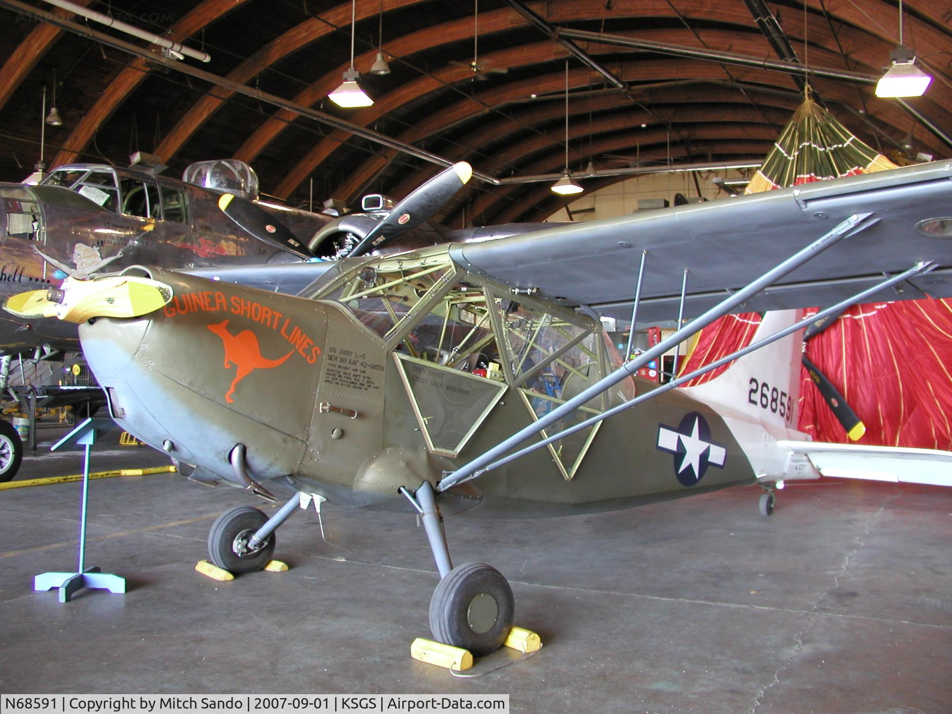 N68591, Stinson L-5 Sentinel C/N 42-98667 (76-908), Parked inside the Commemorative Air Force Hangar.