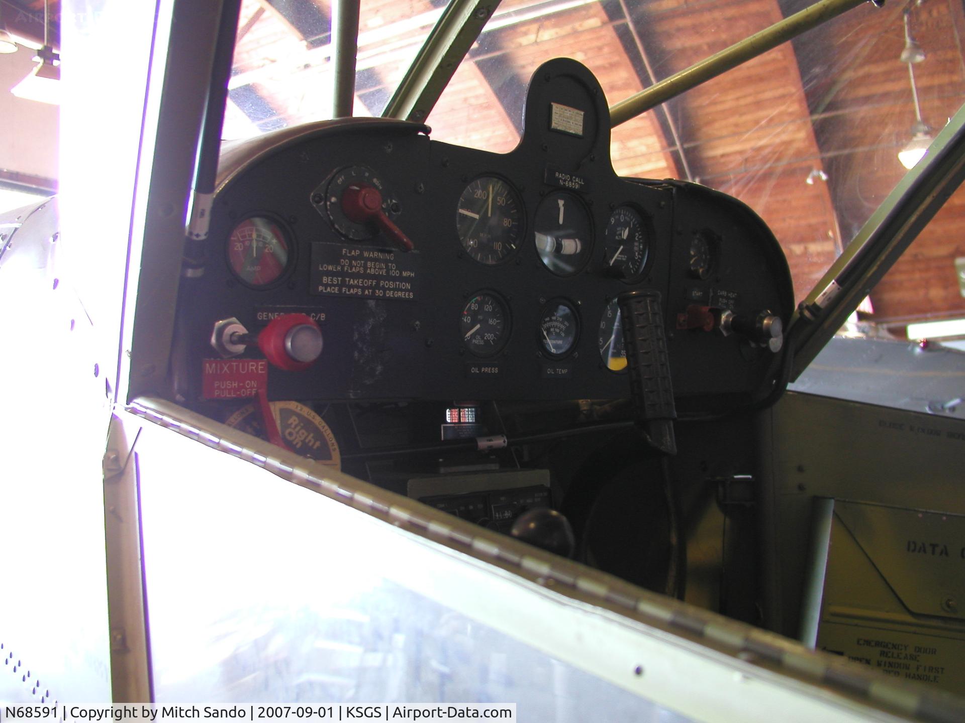 N68591, Stinson L-5 Sentinel C/N 42-98667 (76-908), Parked inside the Commemorative Air Force Hangar.
