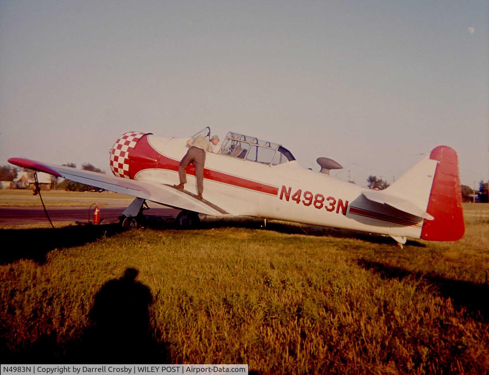 N4983N, 1957 North American AT-6D Texan C/N 121-42175 (44-81453), I took this photo in 1961 at Wiley Post airport, the owner at the time was Jim Frye, he is standing on the wing.