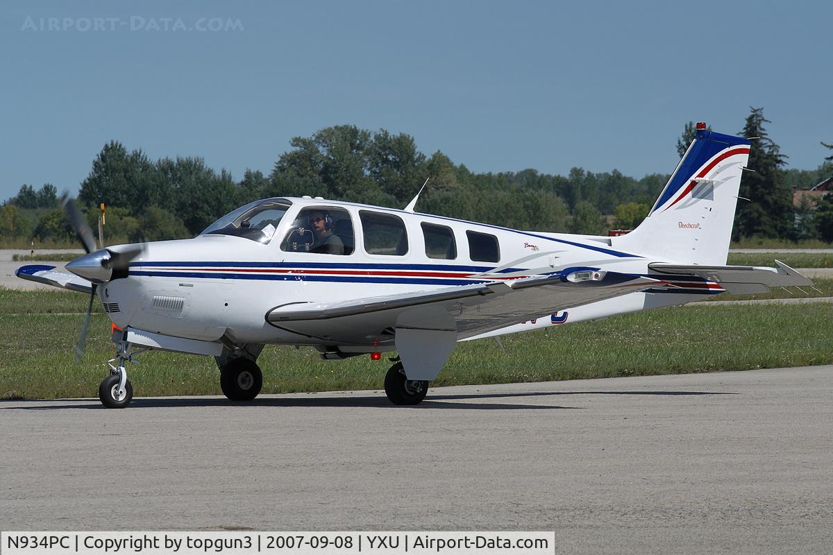 N934PC, 2002 Raytheon Aircraft Company A36 Bonanza C/N E-3448, Taxiing across Ramp III.
