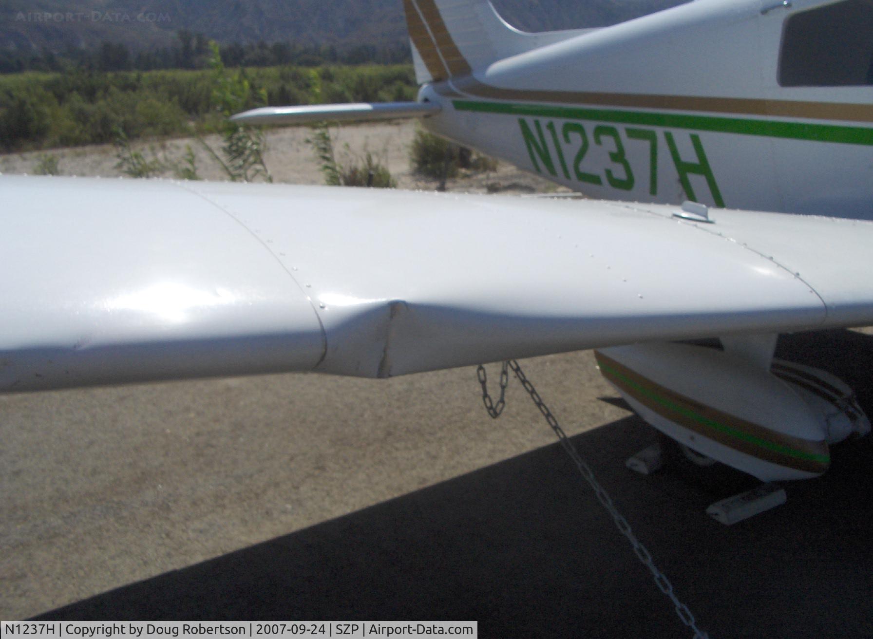 N1237H, Piper PA-28-140 Cruiser C/N 28-7725137, 1976 Piper PA-28-140 CRUISER, Lycoming O-320-E3D 150 Hp, landed hard & long on Rwy 22-bounced twice-overran end and crashed into fence & dirt berm, aircraft totaled by Insurance Co., landing gear, prop, wing dents, fuselage damage, spinner dents