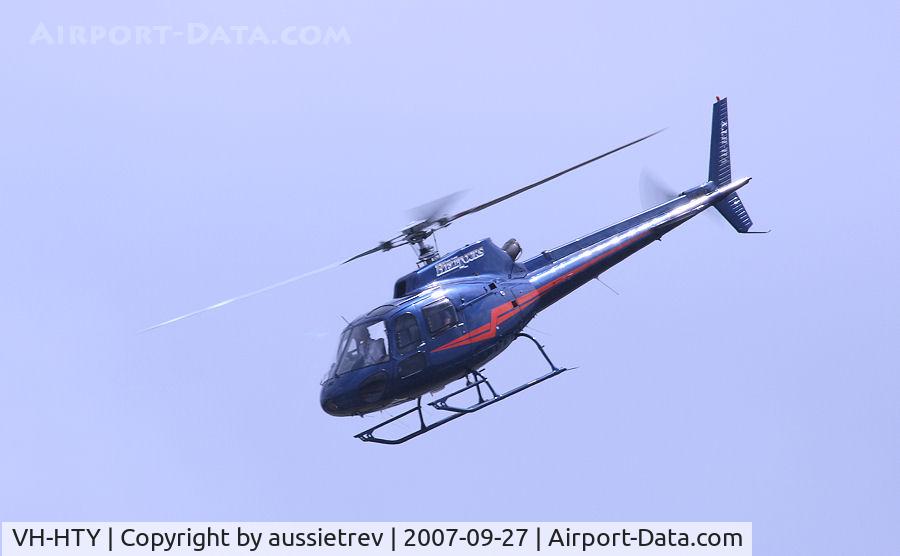 VH-HTY, 1989 Eurocopter AS-350BA Ecureuil C/N 2270, Very low flying Eurocopter bringing buyers for a tour at a land sale