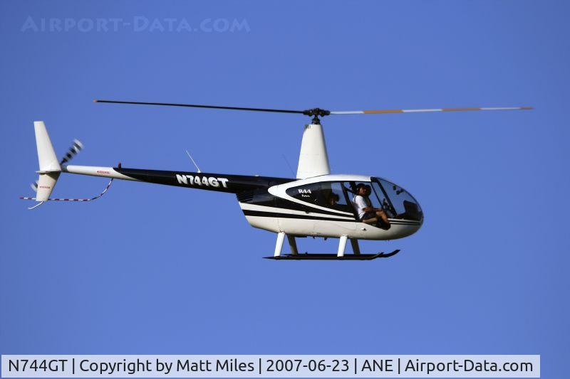 N744GT, 1999 Robinson R44 C/N 0624, crossing the field at 200 feet