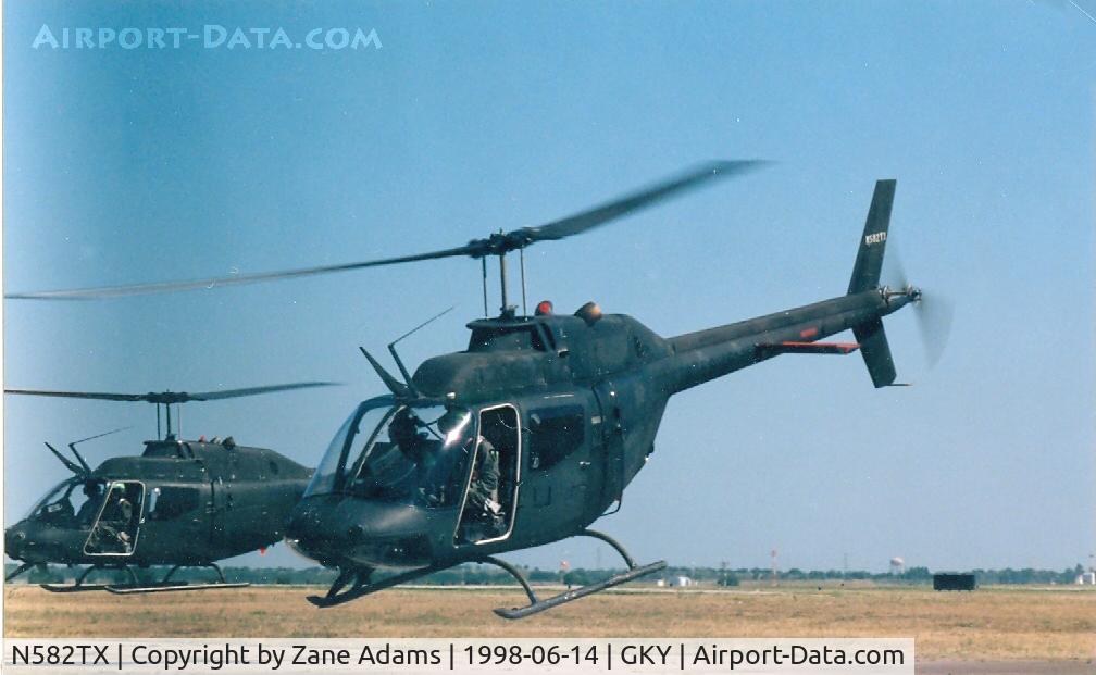 N582TX, 1971 Bell OH-58A C/N 71-20690, 582 in front - Leaving Arlington Muni