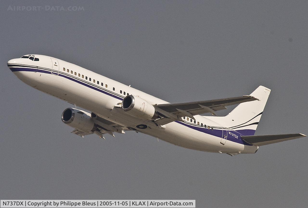 N737DX, 1990 Boeing 737-408 C/N 24804, First class only (large leather seats) Pace Airlines -400, climbing in a clear blue sky.