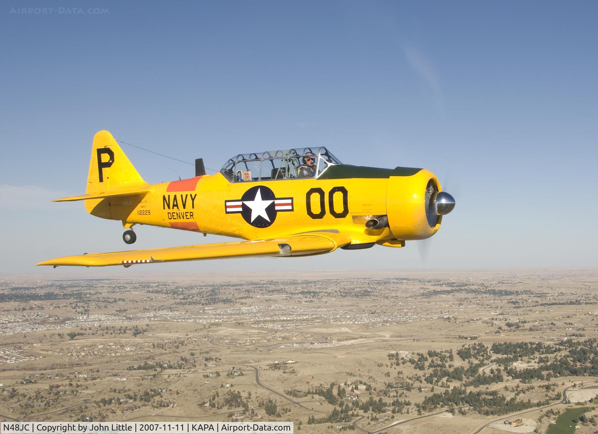 N48JC, North American AT-6G Texan Texan C/N 121-43192, Jack and his beautiful SNJ above the port wing of the Mustang