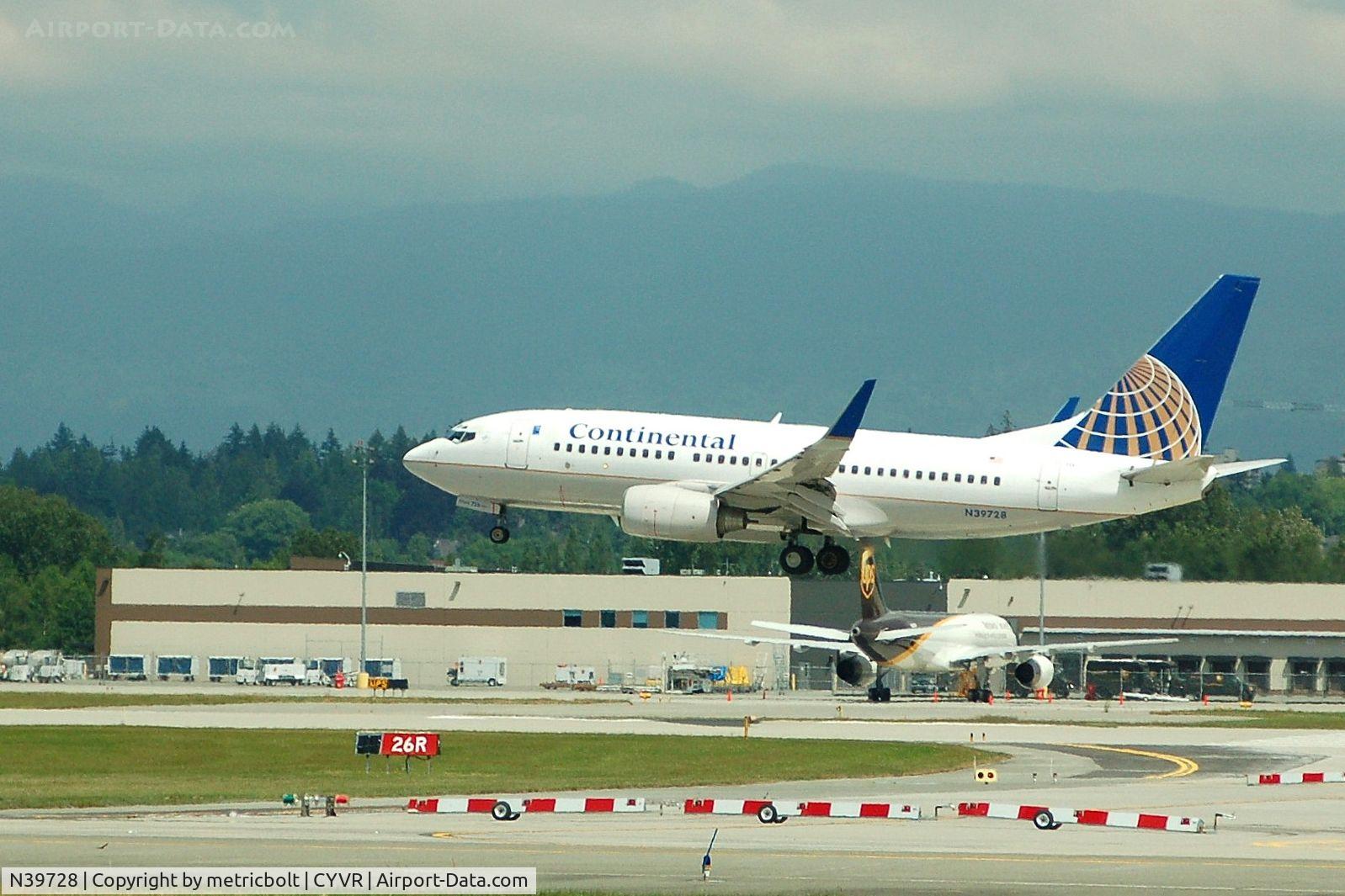 N39728, 1999 Boeing 737-724 C/N 28944, Landing at YVR,UPS cargo facility in background.Summer 2007