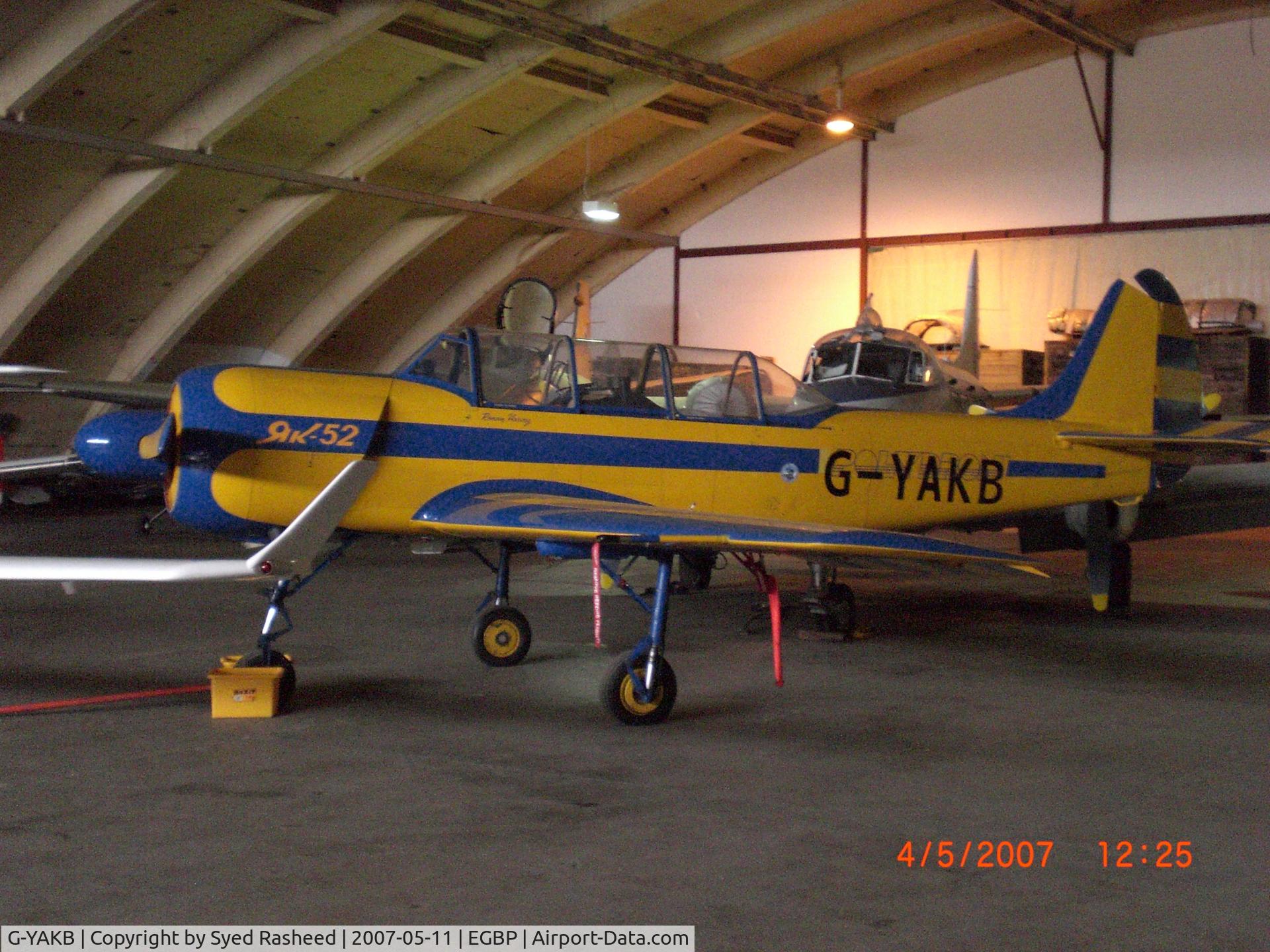 G-YAKB, 1992 Yakovlev (Aerostar) Yak-52 C/N 9211517, Parked in the Delta Jets Hanger