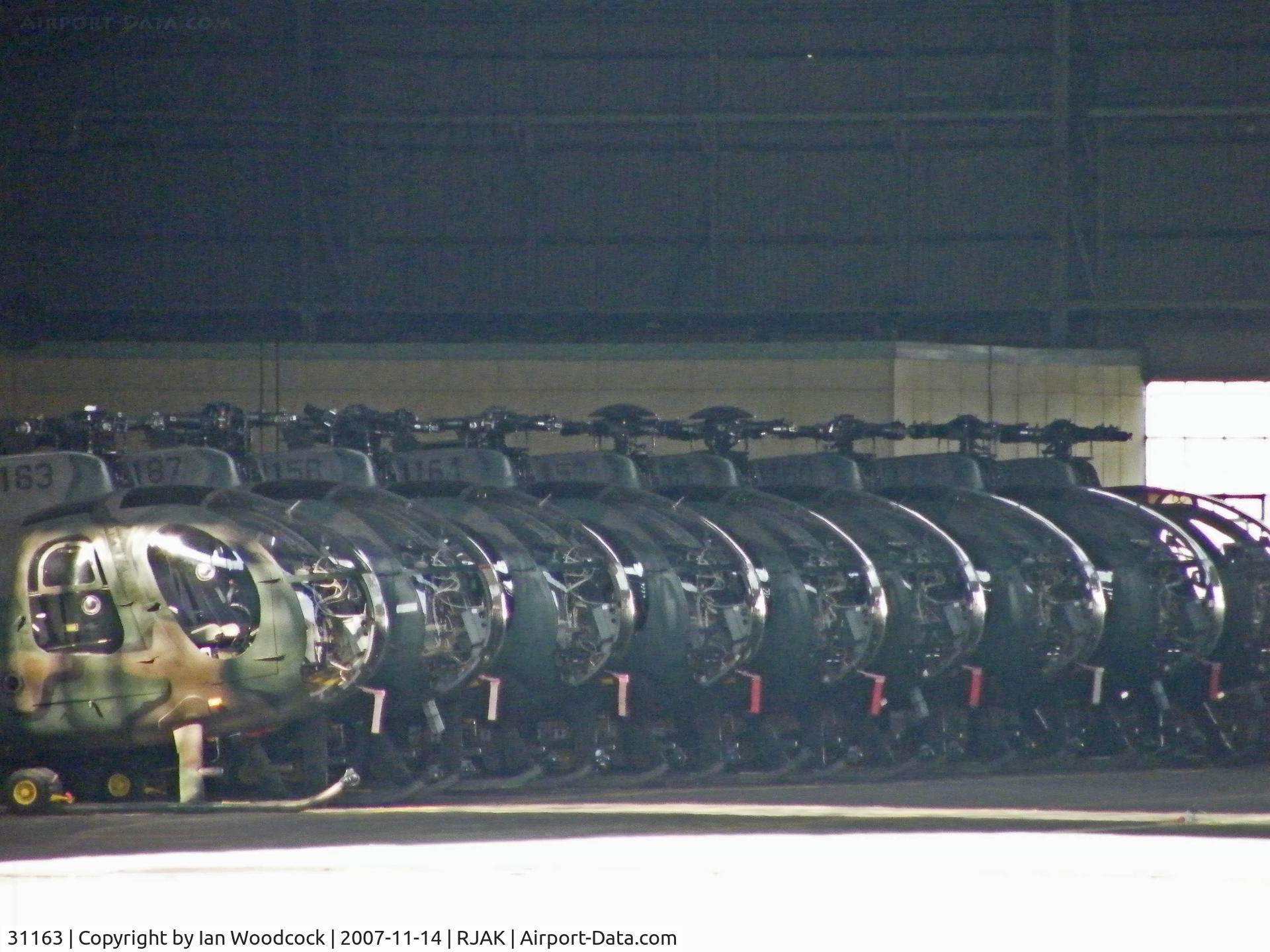 31163, Hughes (Kawasaki) OH-6D (369D) C/N 6464, OH-6D/Kasumigaura (Heads a line of OH-6D's in the hangar)