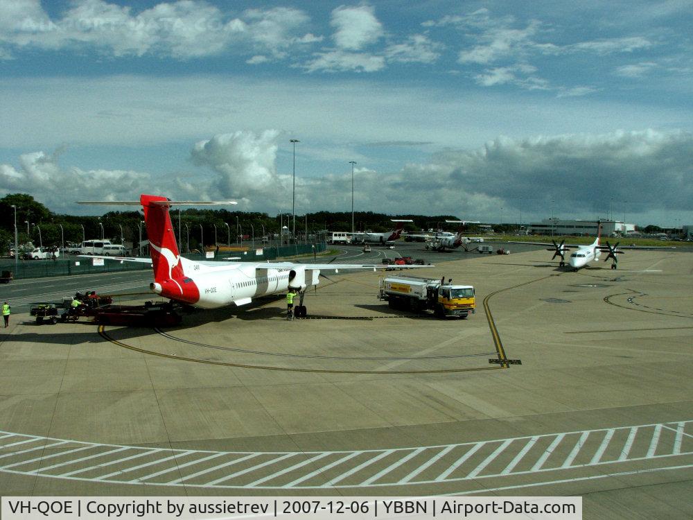 VH-QOE, 2006 De Havilland Canada DHC-8-402Q Dash 8 C/N 4125, De Havilland Canada DHC-8-402Q Dash 8 VH-QOE finishes refuelling as VH-QOB taxis in.