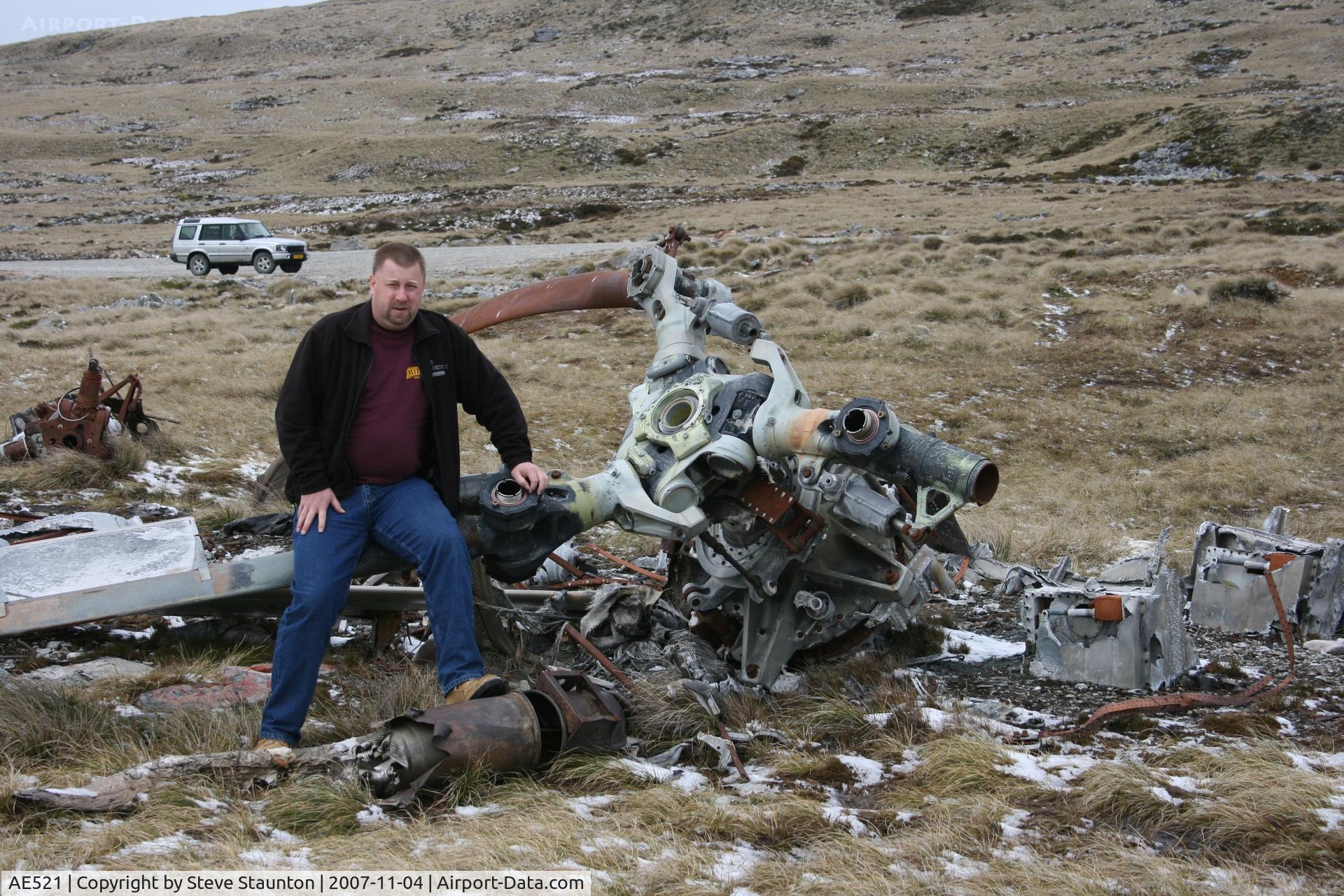 AE521, Boeing Vertol CH-47C Chinook C/N B-789/CG-102, This is me sitting on the wreck of BV Chinook CH-47C of the Argentine AF located at the foot of Mount Kent, Falkland Island. This aircraft was destroyed during the 1982 Falklands Conflict. Notice the snow on the ground - yes a cold Spring November day