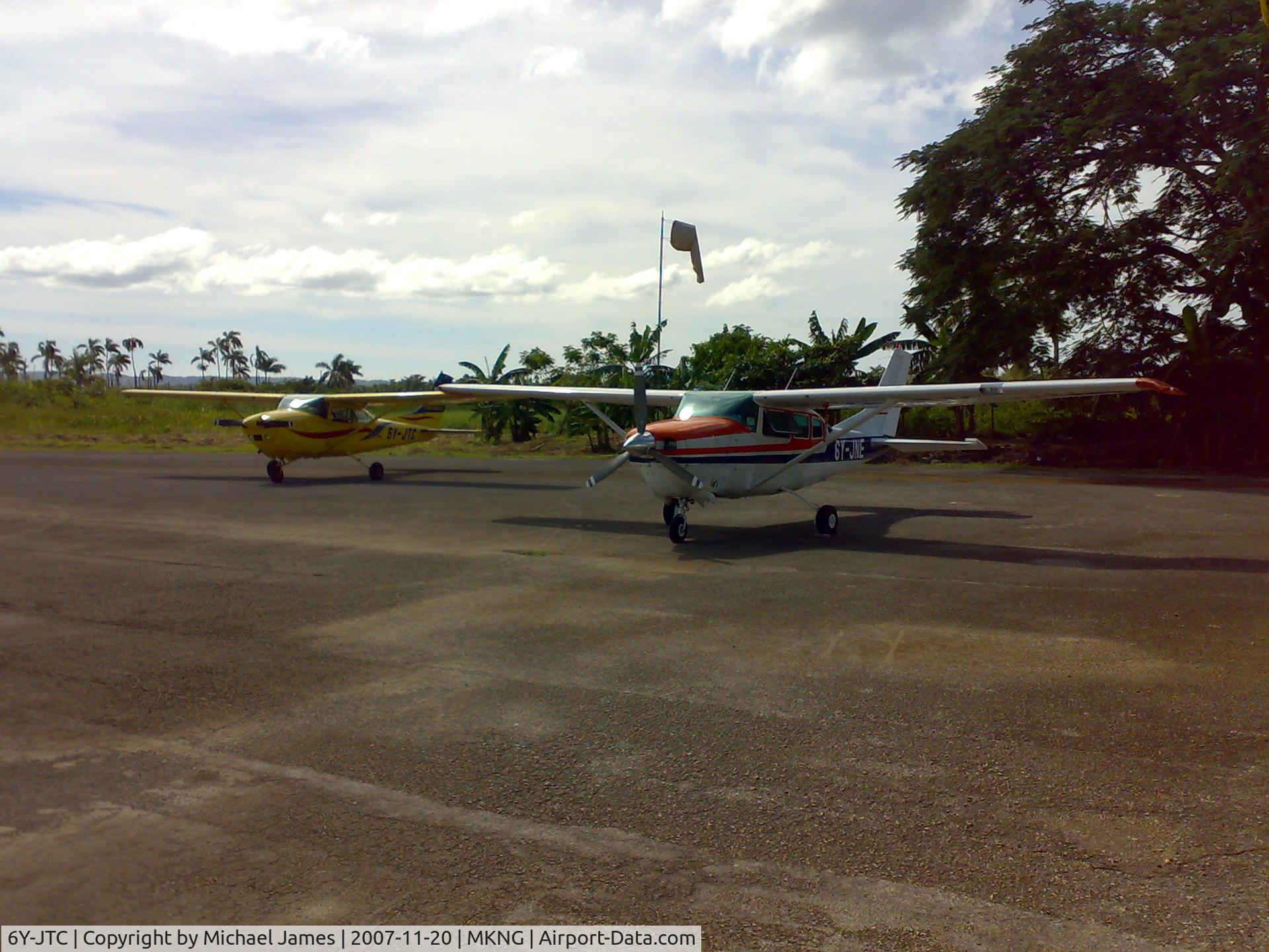 6Y-JTC, Cessna 182Q Skylane C/N 18265231, Picture of Tara Courier Services Ltd aircraft - # 6Y-JTC (Yellow Cessna on the left) Taken at Negril Aerodrome Jamaica