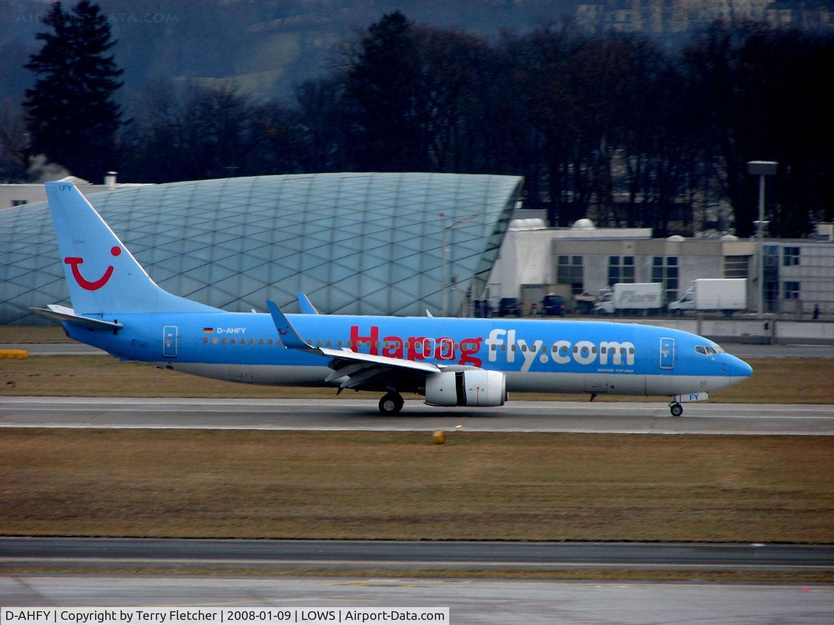 D-AHFY, 2001 Boeing 737-8K5 C/N 30417, HapagFly's B737 passes the Red Bull Maintenance Hangar on arrival to Salzburg