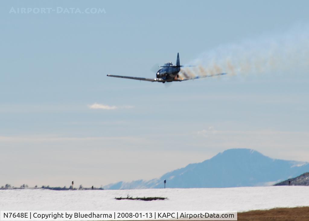 N7648E, 1942 North American SNJ-3 Texan C/N 78-6987, Trophy Hunter does a Tower flyby with smoke. Pikes Peak in the distance.