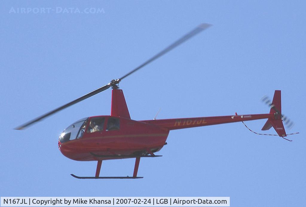 N167JL, 2005 Robinson R44 II C/N 10782, S 12 helicopter hovering over the Pacific Ocean.