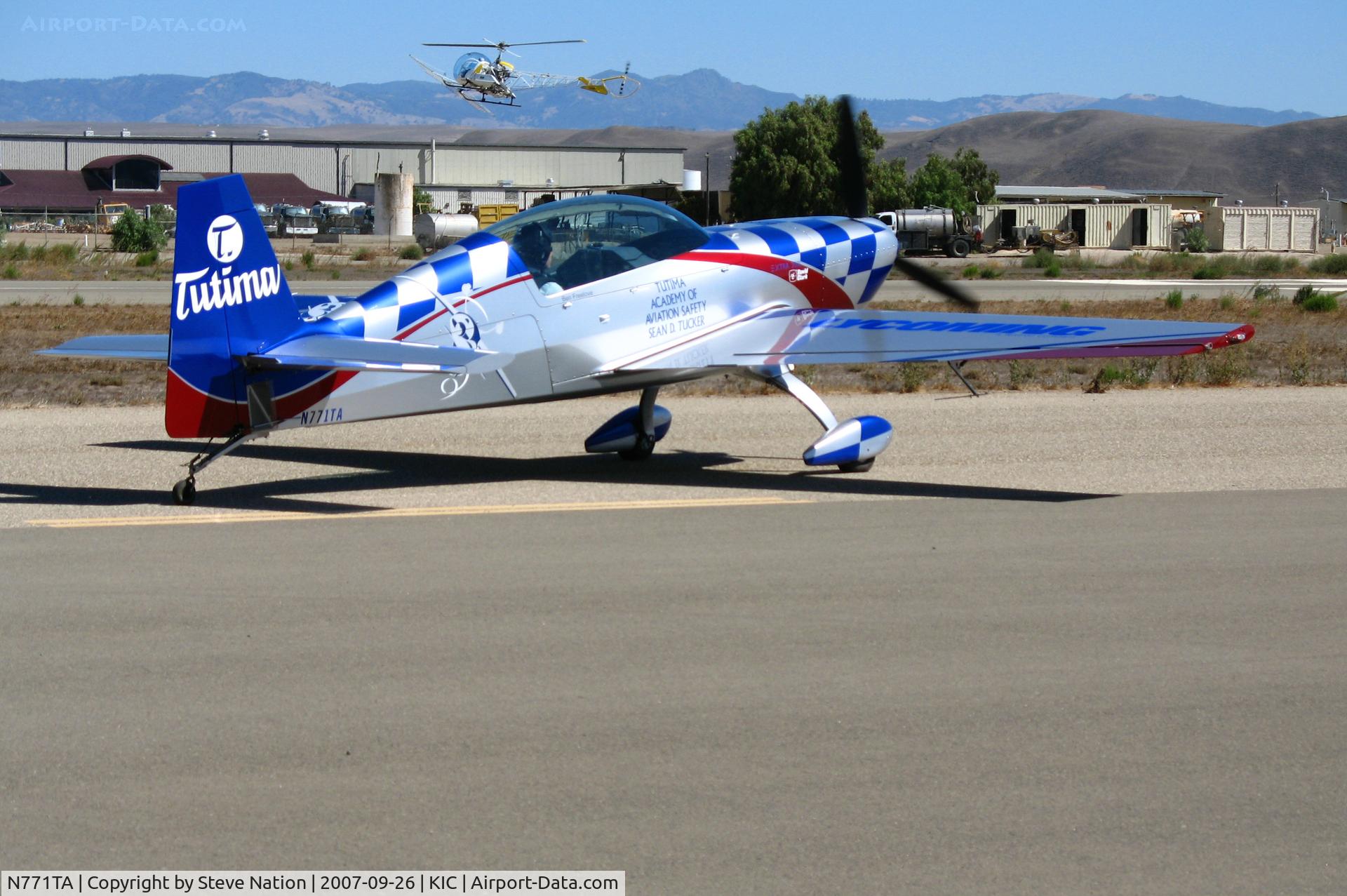 N771TA, 2006 Extra EA-300/L C/N 1231, (Team Oracle) Tutima 2006 Extra Flugzeugbau Gmbh EA 300/L taxying (note SoilServ Bell 47G cropduster on approach) @ Mesa del Rey (King City) Airport, CA