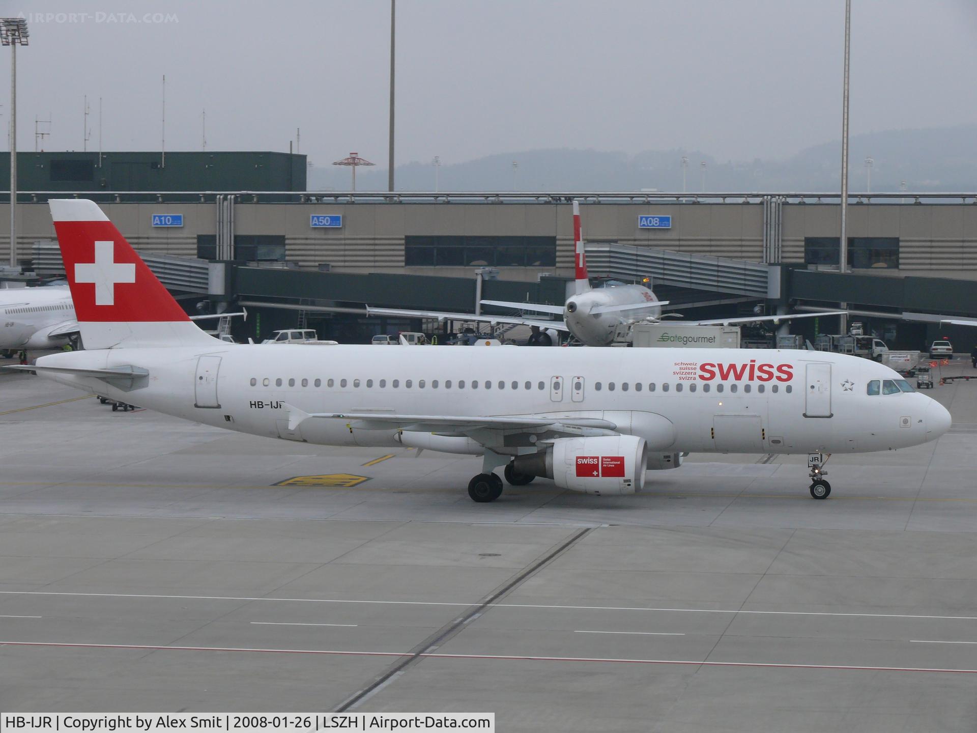 HB-IJR, 1997 Airbus A320-214 C/N 0703, Rolling to it's parking spot in dark weather