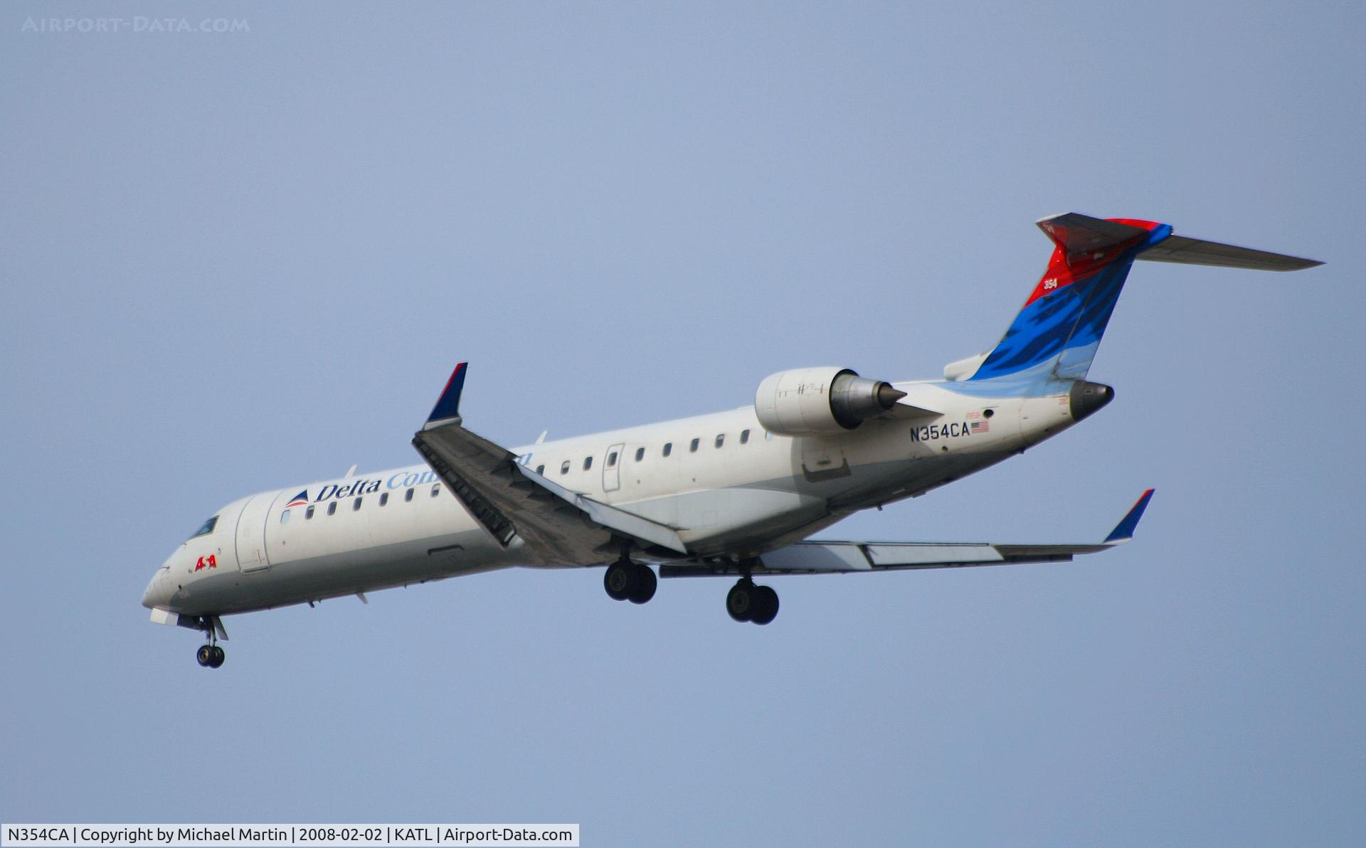 N354CA, 2002 Bombardier CRJ-701ER (CL-600-2C10) Regional Jet C/N 10064, Over the numbers of 26R