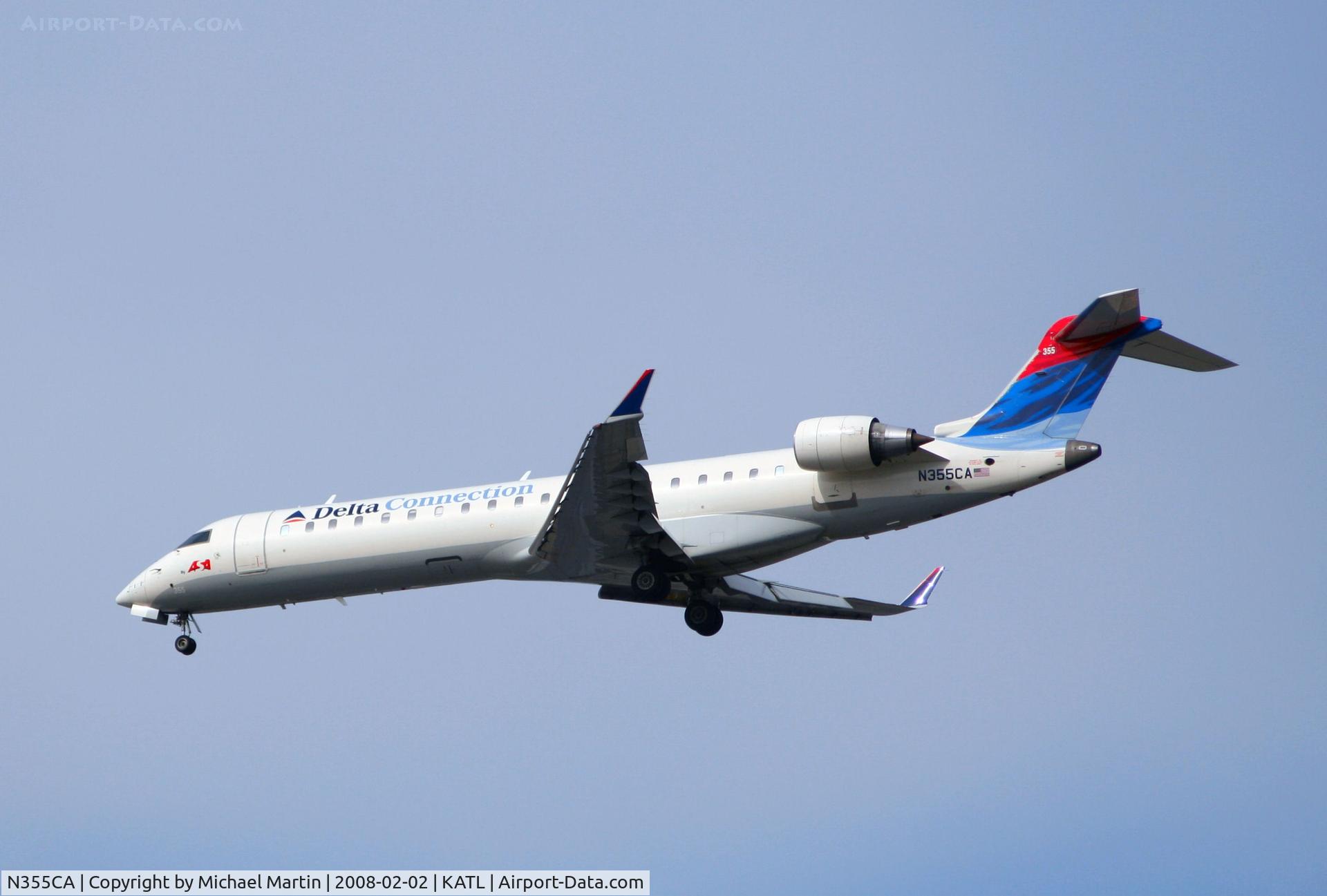 N355CA, 2002 Bombardier CRJ-701ER (CL-600-2C10) Regional Jet C/N 10067, Over the numbers of 26R
