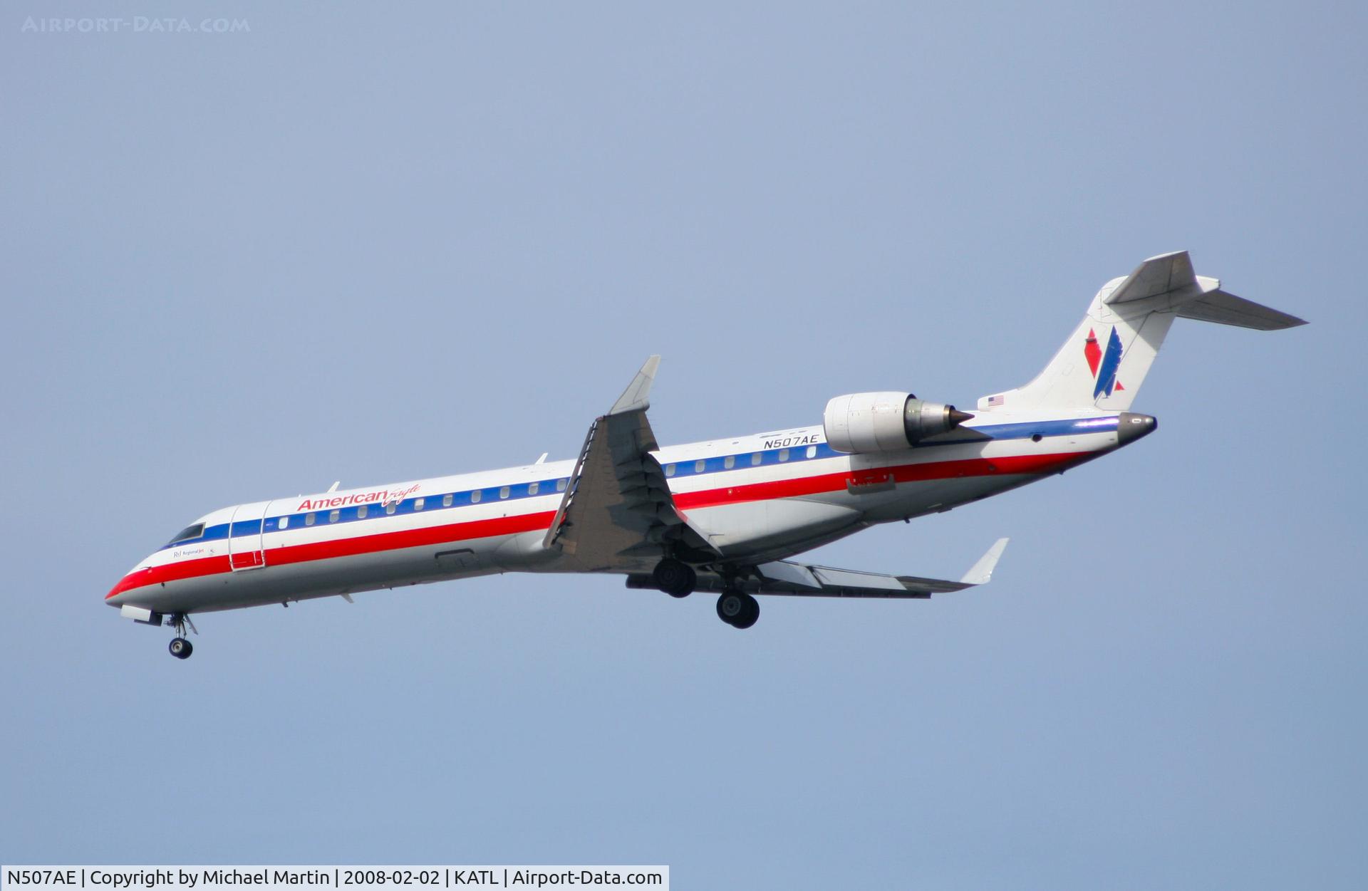 N507AE, 2002 Bombardier CRJ-701 (CL-600-2C10) Regional Jet C/N 10059, Over the numbers of 26R