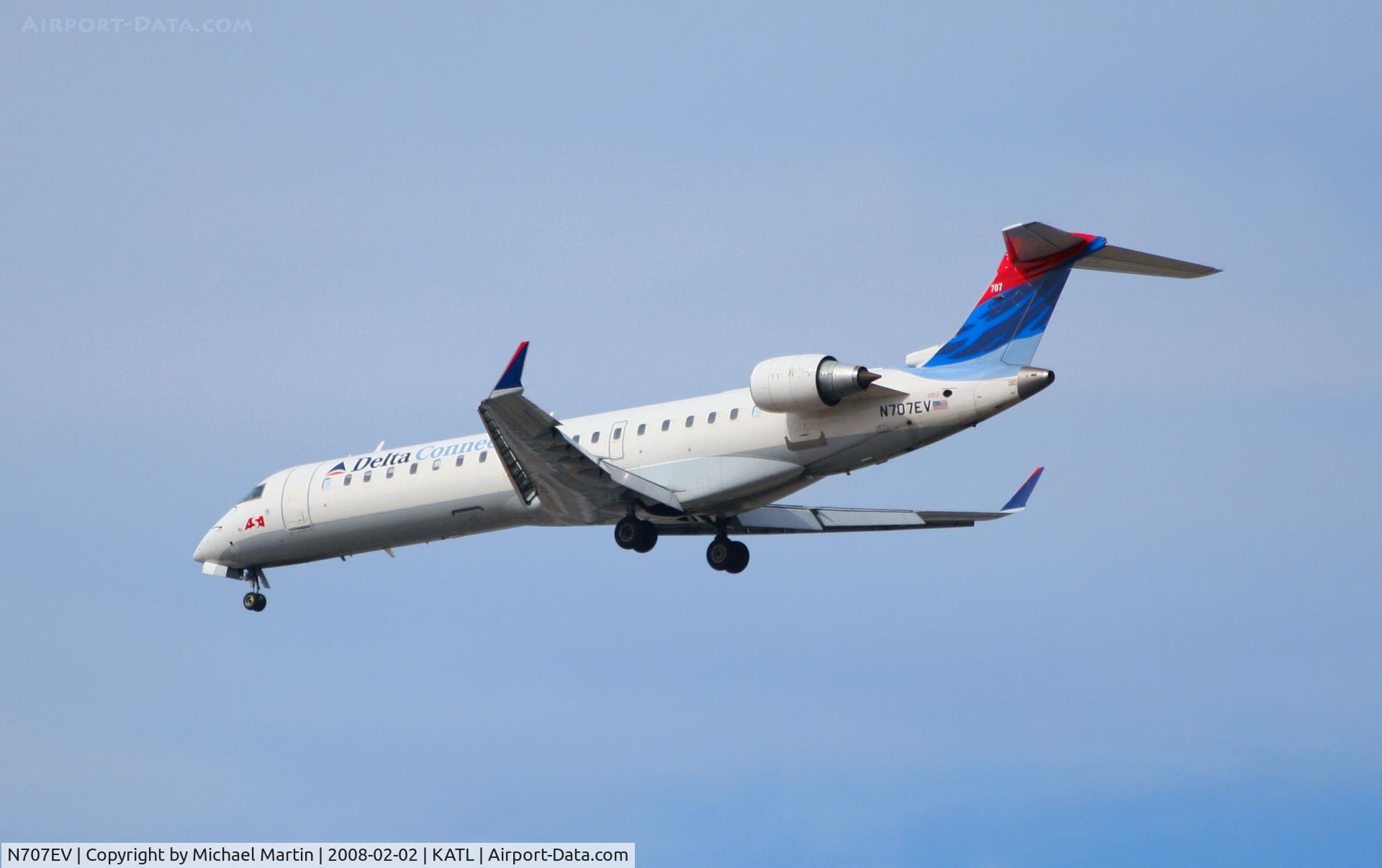 N707EV, 2002 Bombardier CRJ-701 (CL-600-2C10) Regional Jet C/N 10057, Over the numbers of 26R