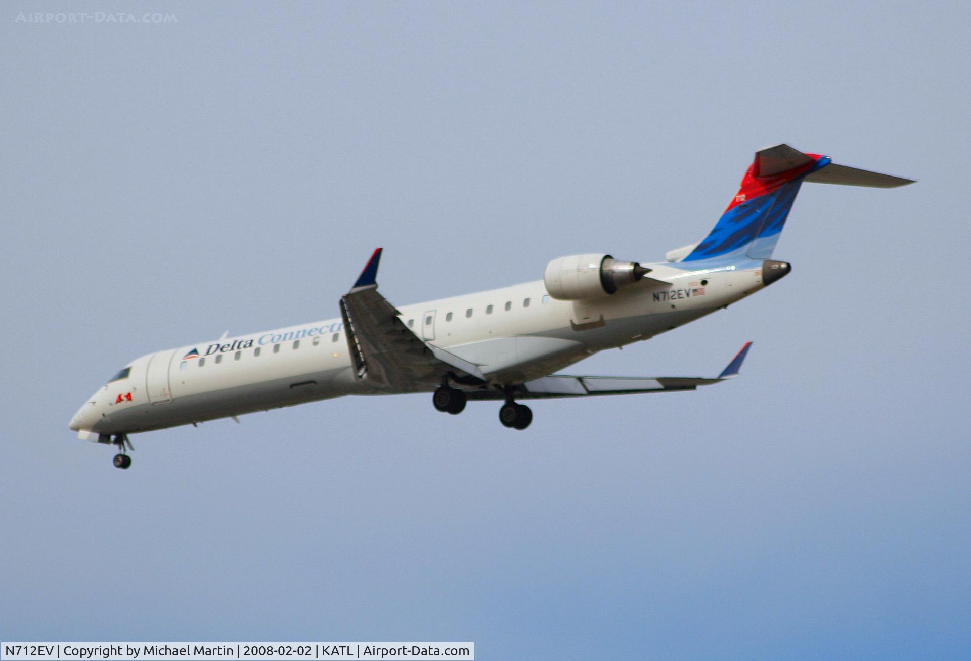 N712EV, 2002 Bombardier CRJ-701ER (CL-600-2C10) Regional Jet C/N 10074, Over the numbers of 26R