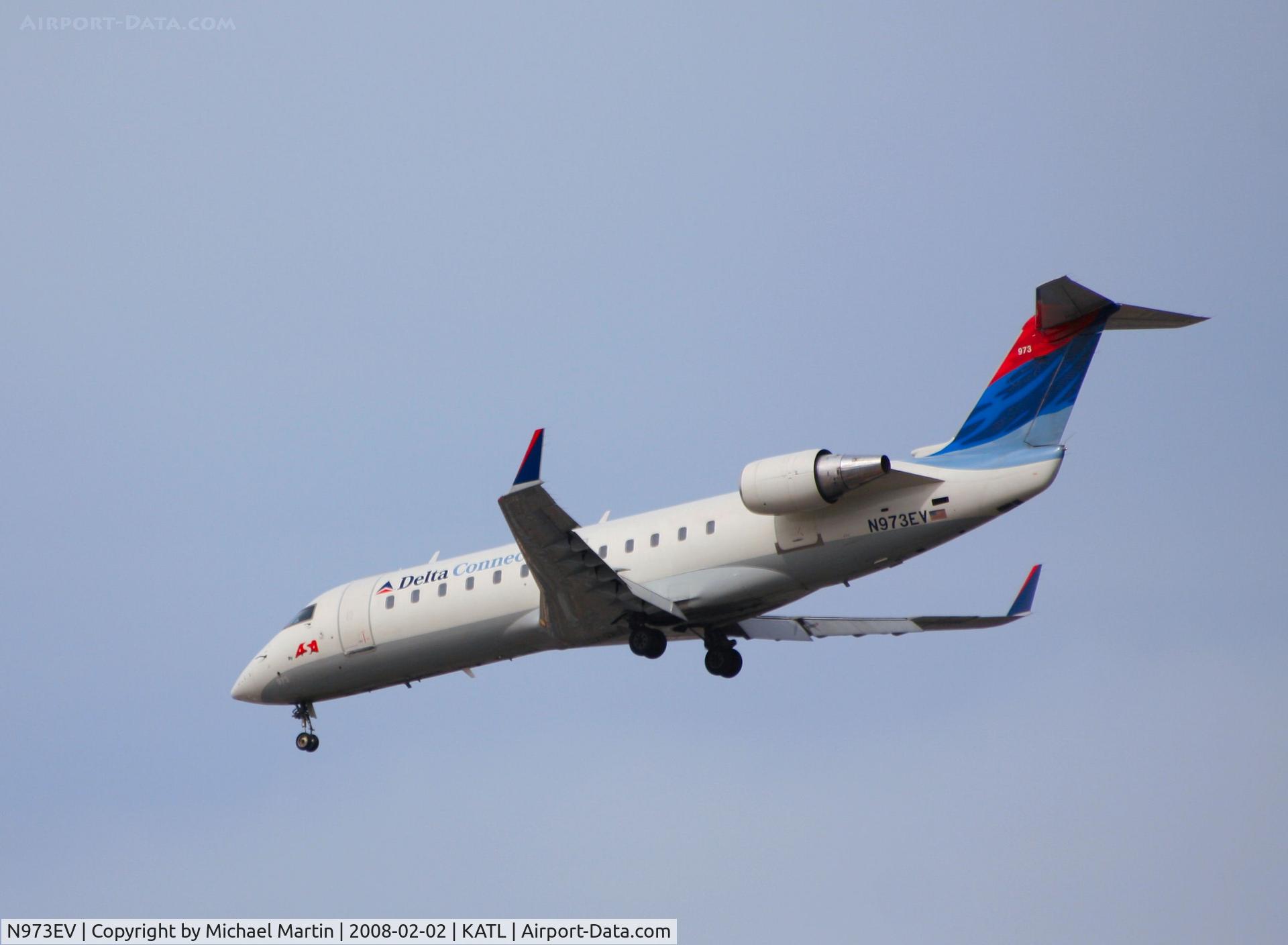 N973EV, 2002 Bombardier CRJ-200ER (CL-600-2B19) C/N 7575, Over the numbers of 26R