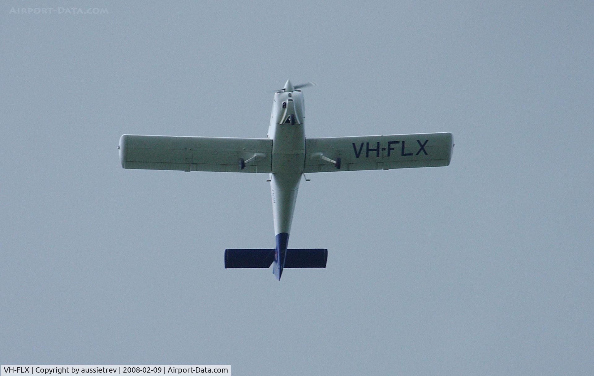 VH-FLX, 1979 Piper PA-38-112 Tomahawk Tomahawk C/N 38-79A1146, Flying under storm clouds west bound over the Gold Coast