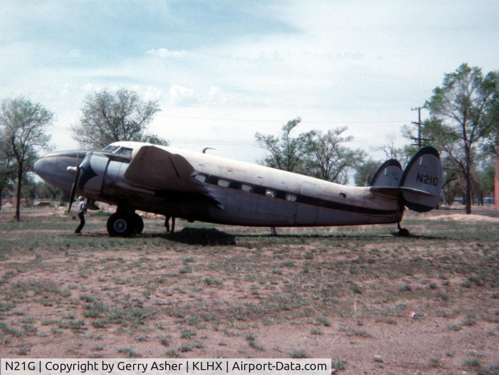 N21G, 1943 Lockheed 18-56 Lodestar C/N 2326, Taken May 1977 at LaJunta, Colorado. She'd rolled back into a large tank during a bout with high winds and crushed the tail cone.