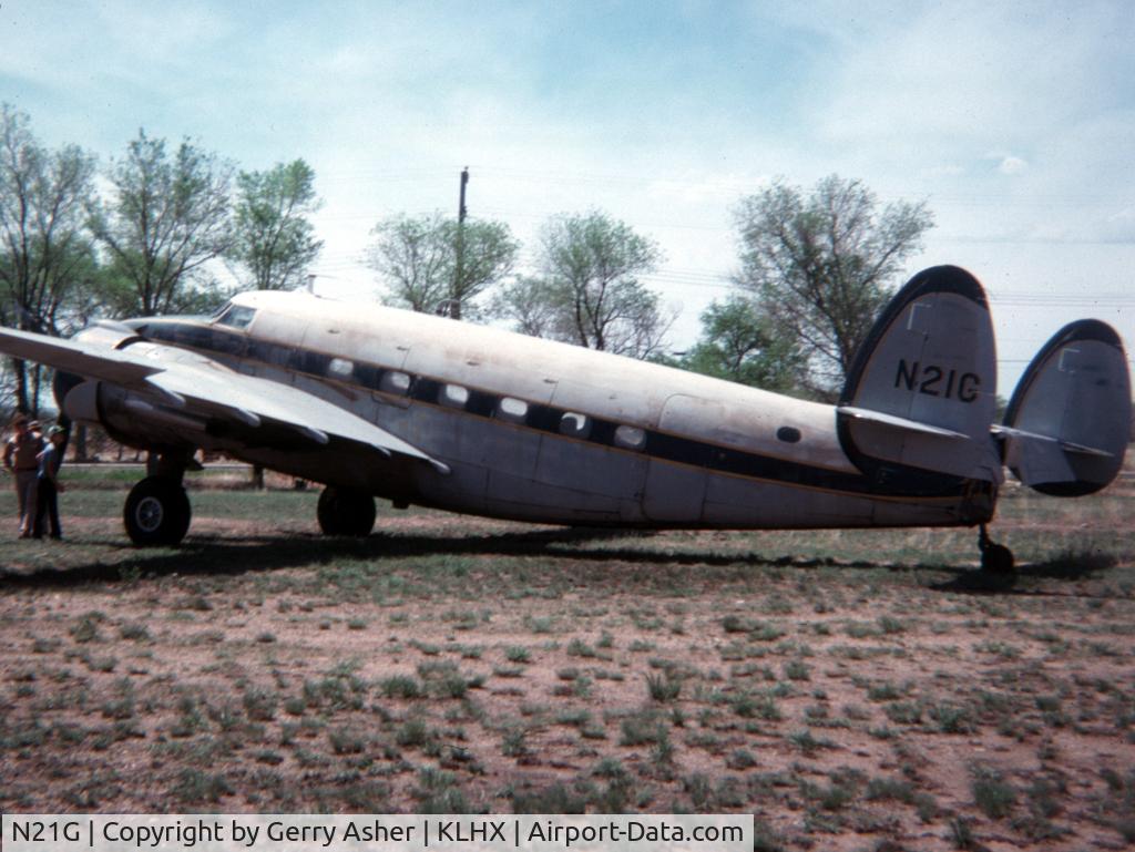 N21G, 1943 Lockheed 18-56 Lodestar C/N 2326, Taken May 1977 at LaJunta, Colorado. She'd rolled back into a large tank during a bout with high winds and crushed the tail cone.