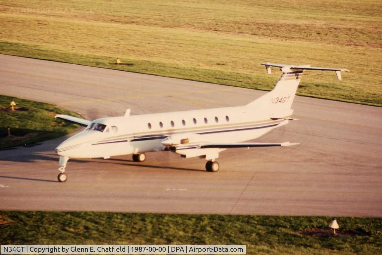 N34GT, 1985 Beech 1900C C/N UB-43, Photo taken for aircraft recognition training.  Ex-N34GT, passing the control tower.  Became N565M then C-GBPC.  Was first aircraft of its type.