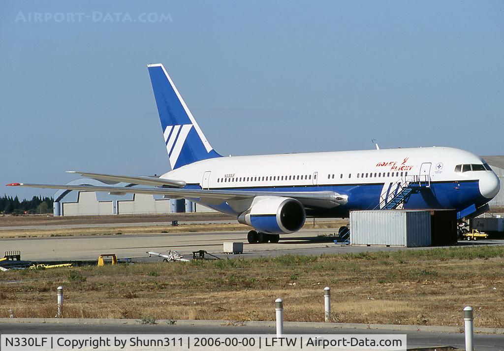 N330LF, 1989 Boeing 767-2Q8/ER C/N 24448, Nice to get this aircraft stored at the Sabena maintenance area... Unfortunately with obstructing foregrounds objects in front of him :-|
