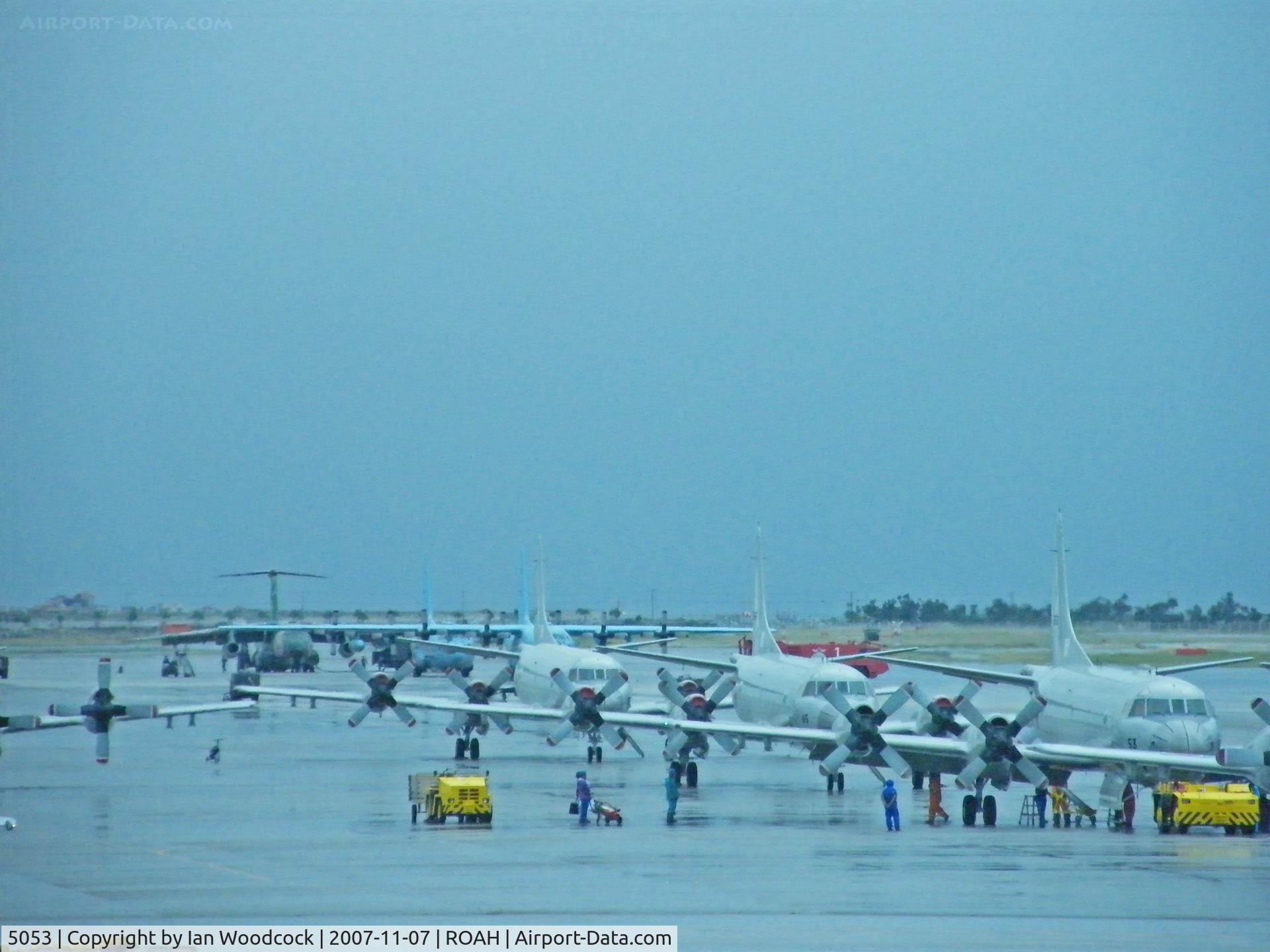 5053, 1989 Kawasaki (Lockheed) P-3C-III Orion C/N 9050, Lockheed P-3C/Heads a gaggle on a wet Naha ramp.