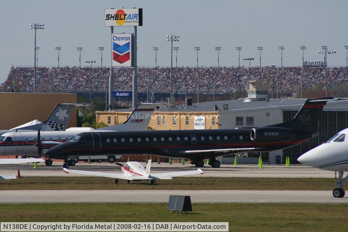 N138DE, 1999 Embraer EMB-145LU (ERJ-145LU) C/N 145129, Dale Earnhart Inc's new E145 parked with Daytona Speedway in background