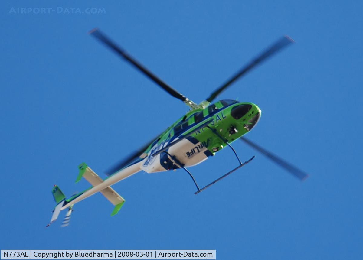 N773AL, 1997 Bell 407 C/N 53160, AirLife Denver heading west over Columbine High School.