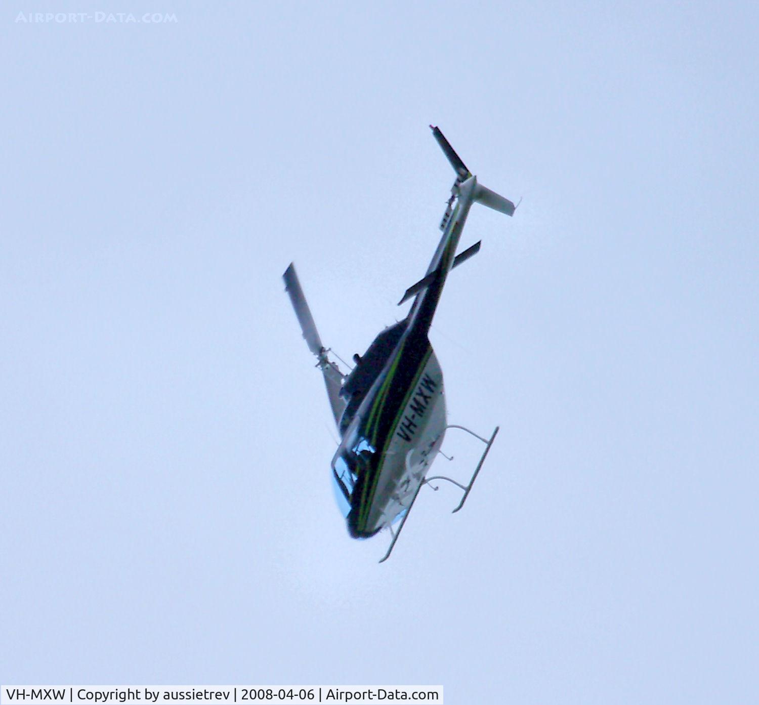 VH-MXW, 1974 Bell 206B JetRanger II C/N 1198, This copter did a low high speed loop around the hill behind my house. No idea what it was up to. This is the actual attitude he had on as he dove behind the hill, not a rotated pic